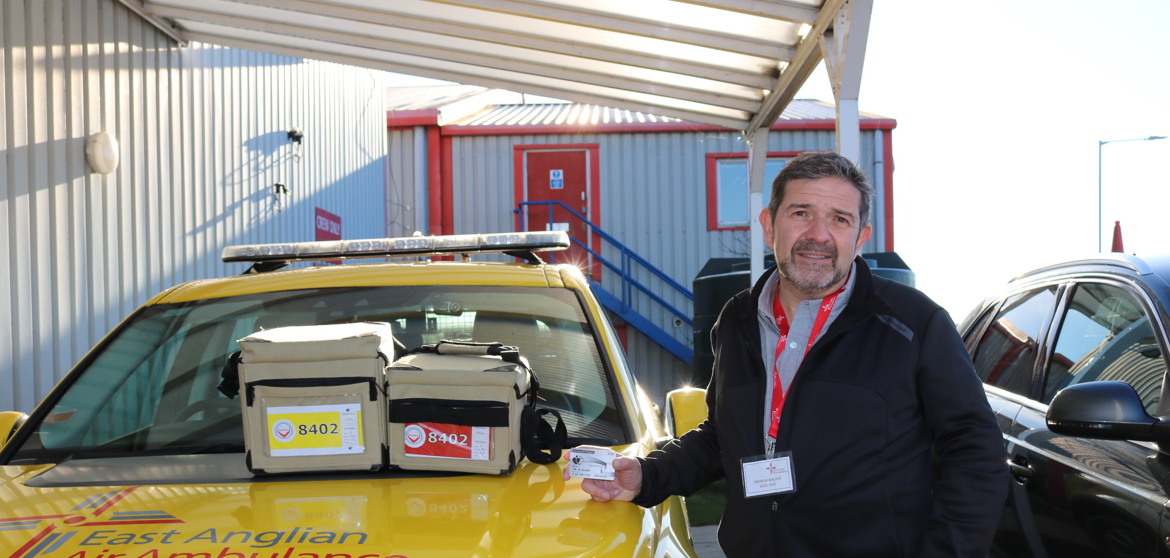 Andrew Walker standing beside the RRV with kit bags containing blood products.