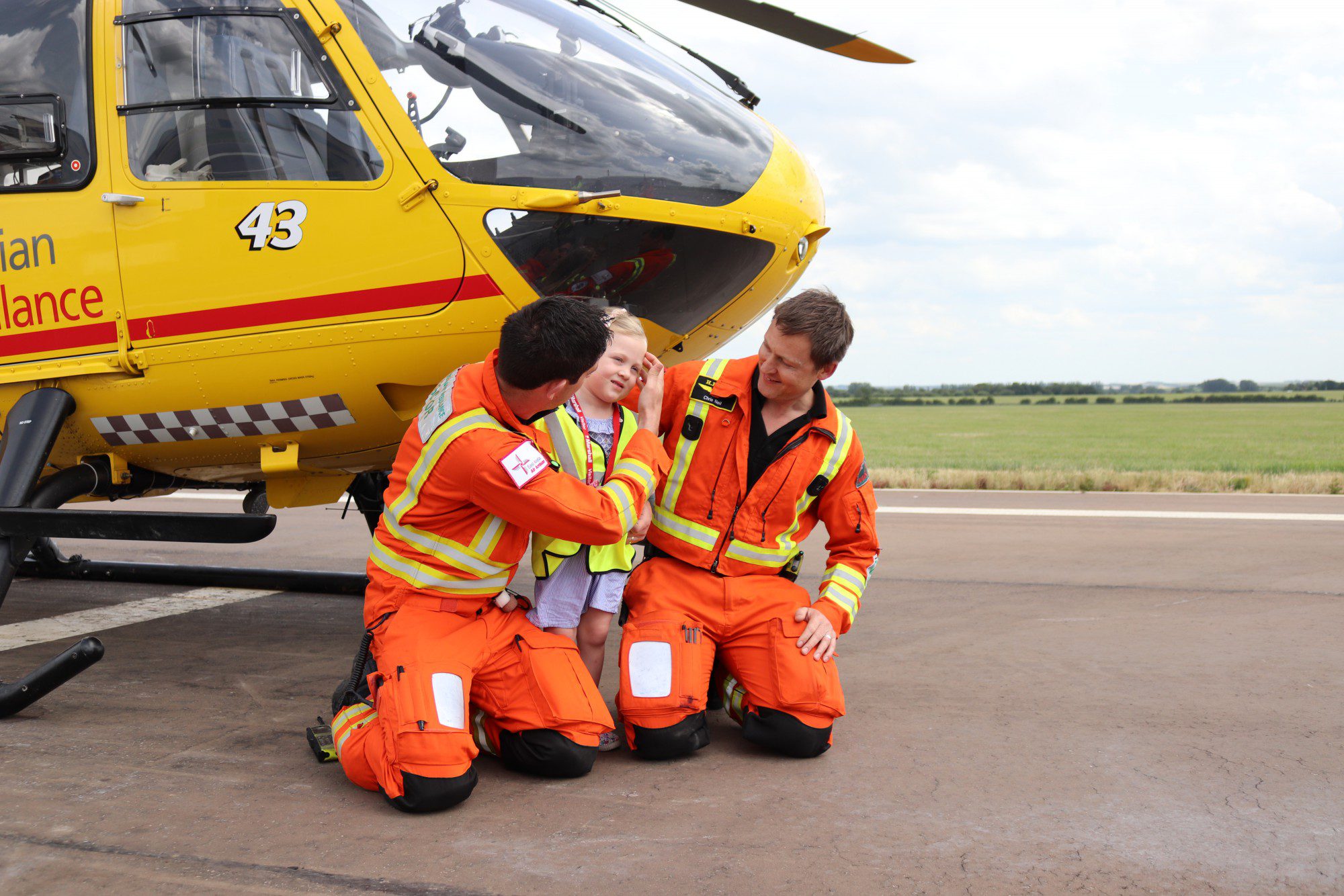 Annabel Brightwell with EAAA crew in front of the helicopter