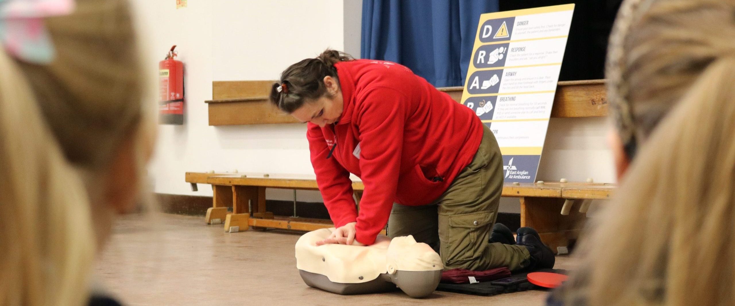 EAAA Volunteer showing people how to do CCPR chest compressions