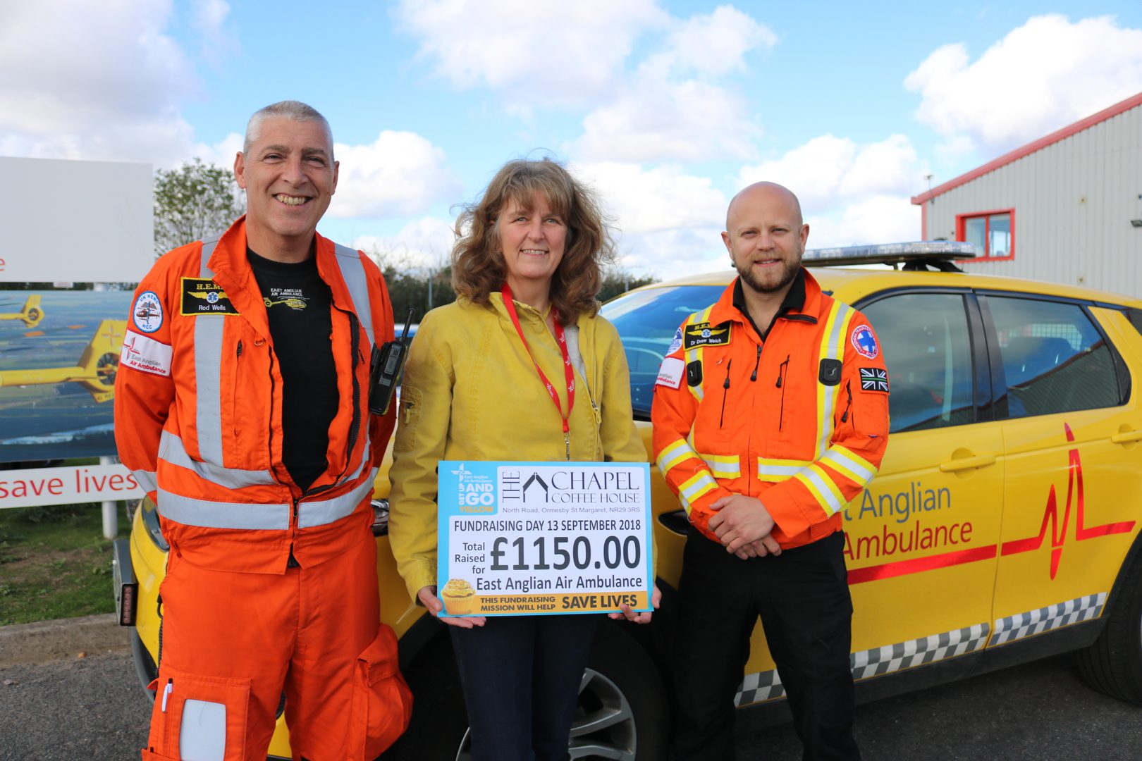 Carolyn Skipper with CCP Rod Wells and Dr Drew Welch in front of an RRV with a fundraising cheque.