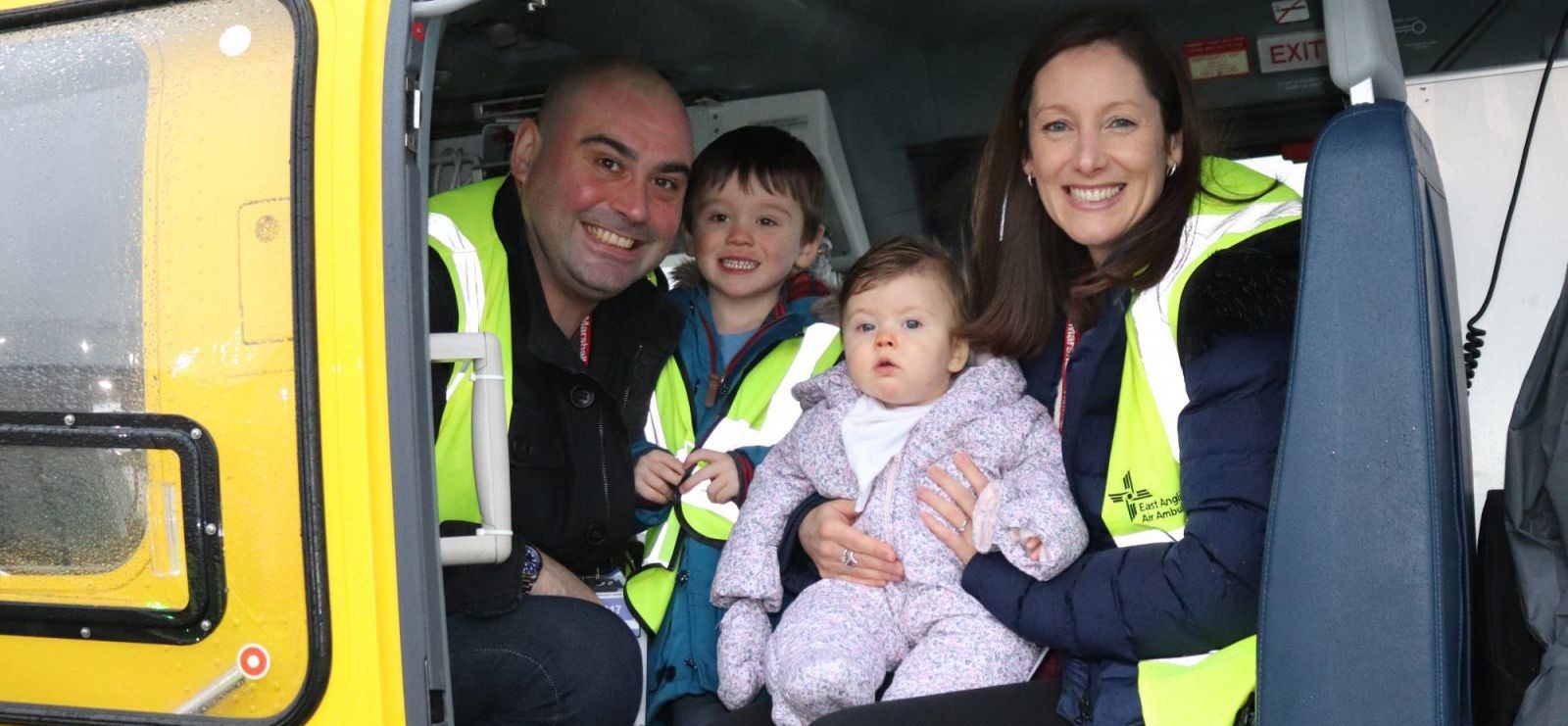 Emma Howard, Baby Willow and their family siting inside the EAAA helicopter.