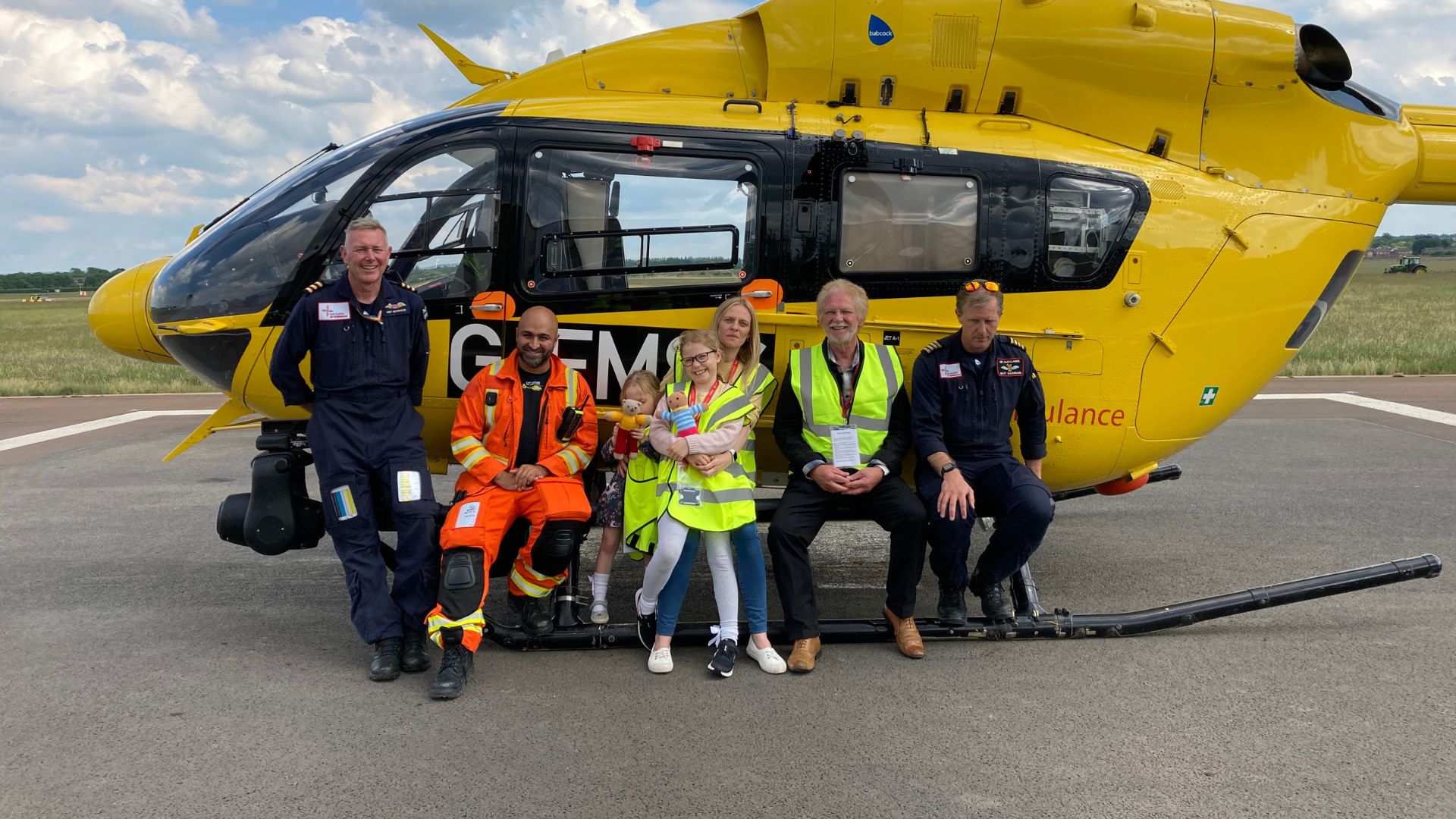 Hayley Bellchambers and her family pictured with the EAAA crew in front of the helicopter.