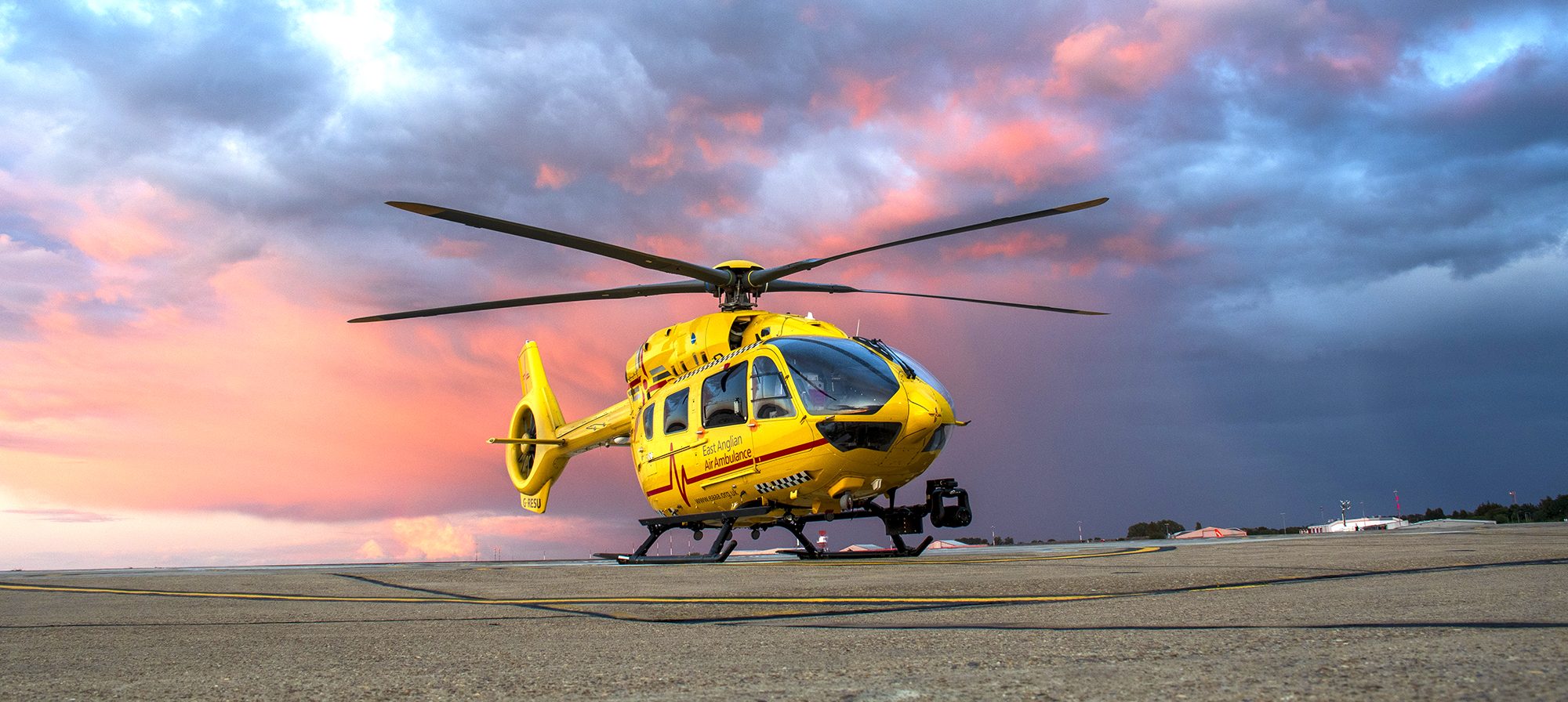 helicopter with red skies behind