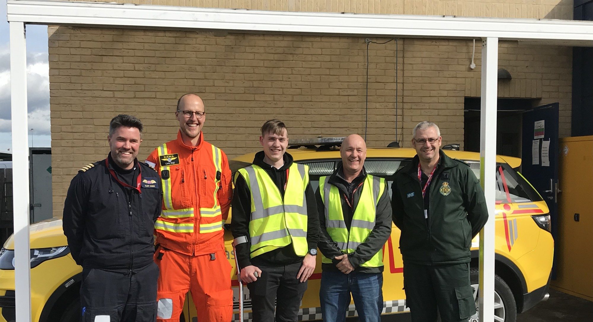 Jonathan Waddingham and colleague with the EAAA crew and EEAST paramedic standing in front of the Anglia Two RRV.