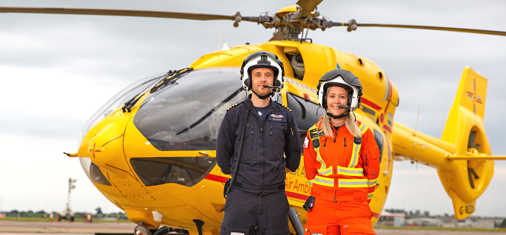 Doctor and paramedic with helicopter