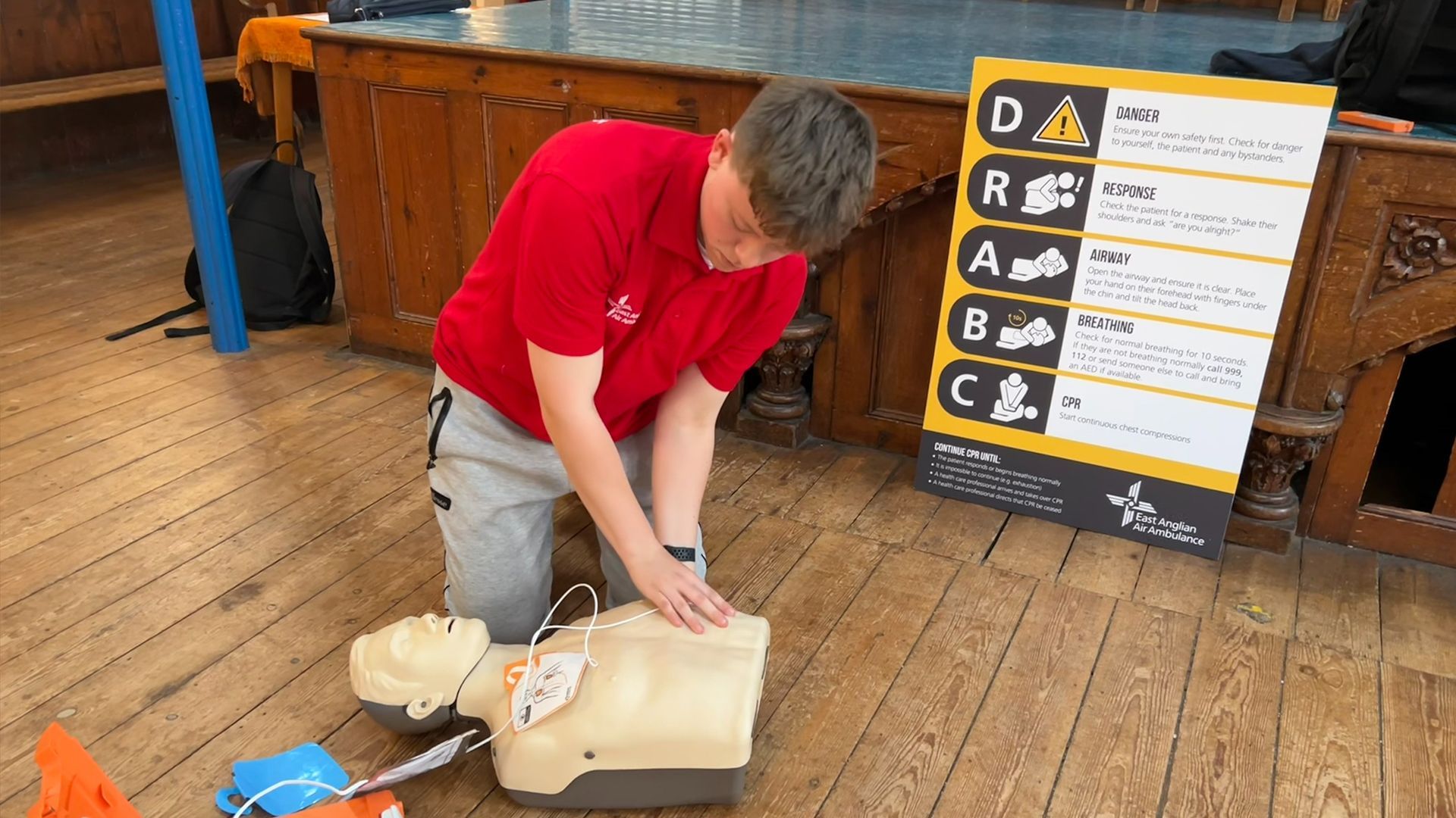 CPR Volunteer Riley White demonstrating chest compressions