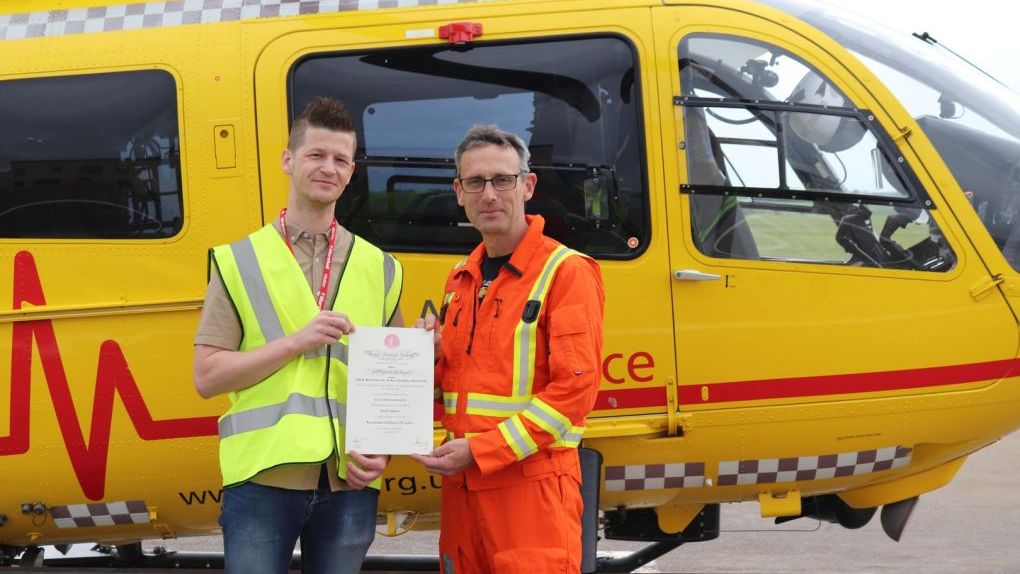 Daniel Challenor holding Royal Humane Society award with Critical care Paramedic Gary Spitzer