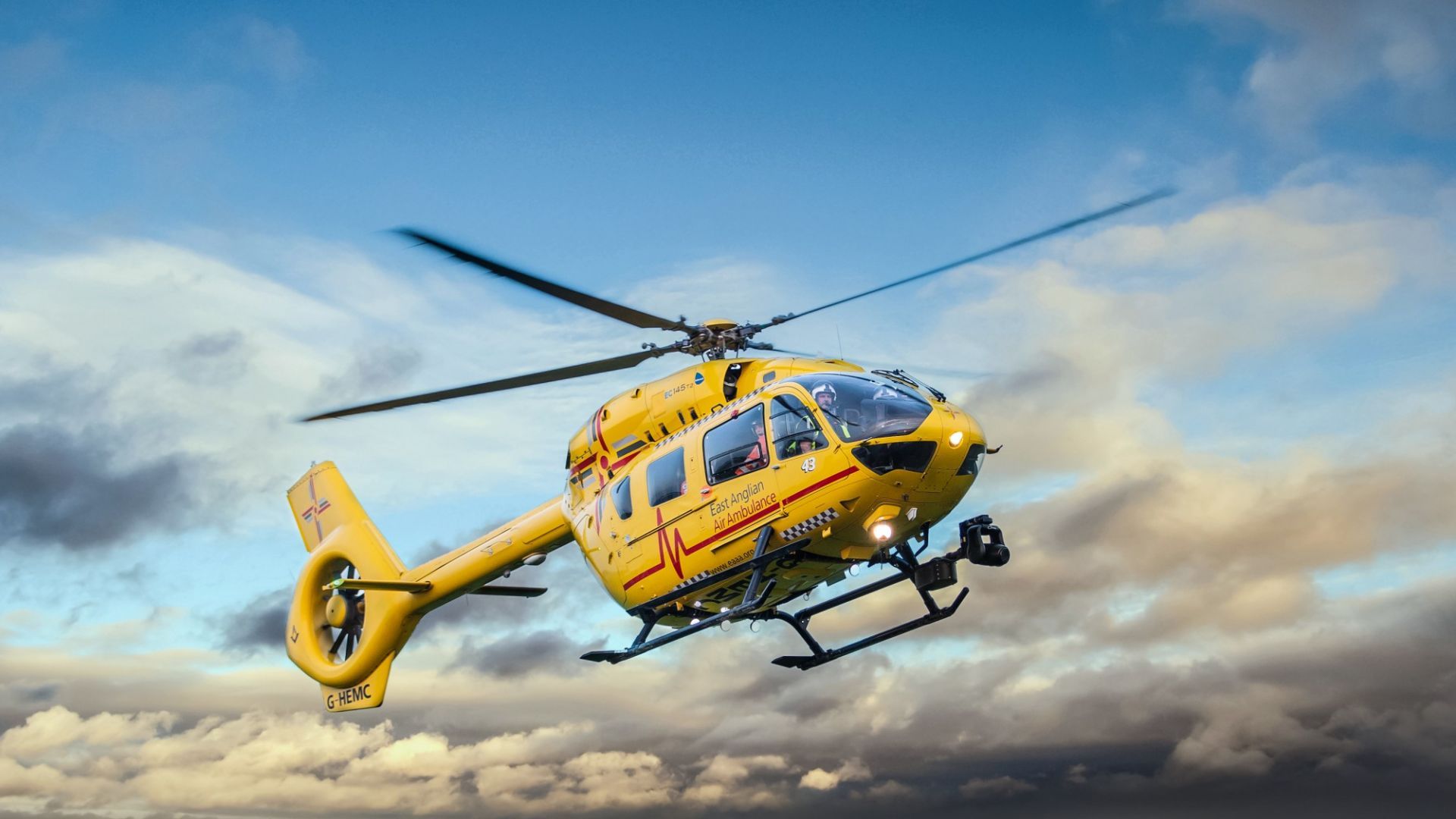 Helicopter landing with cloudy blue skies