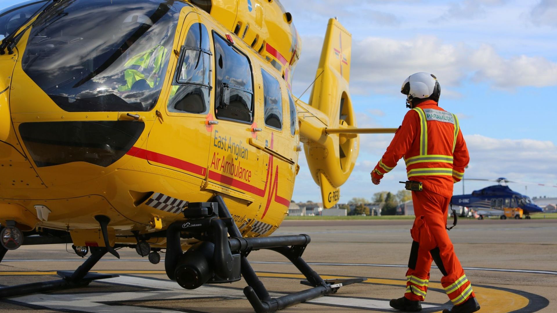 Critical Care Paramedic walking towards air ambulance helicopter