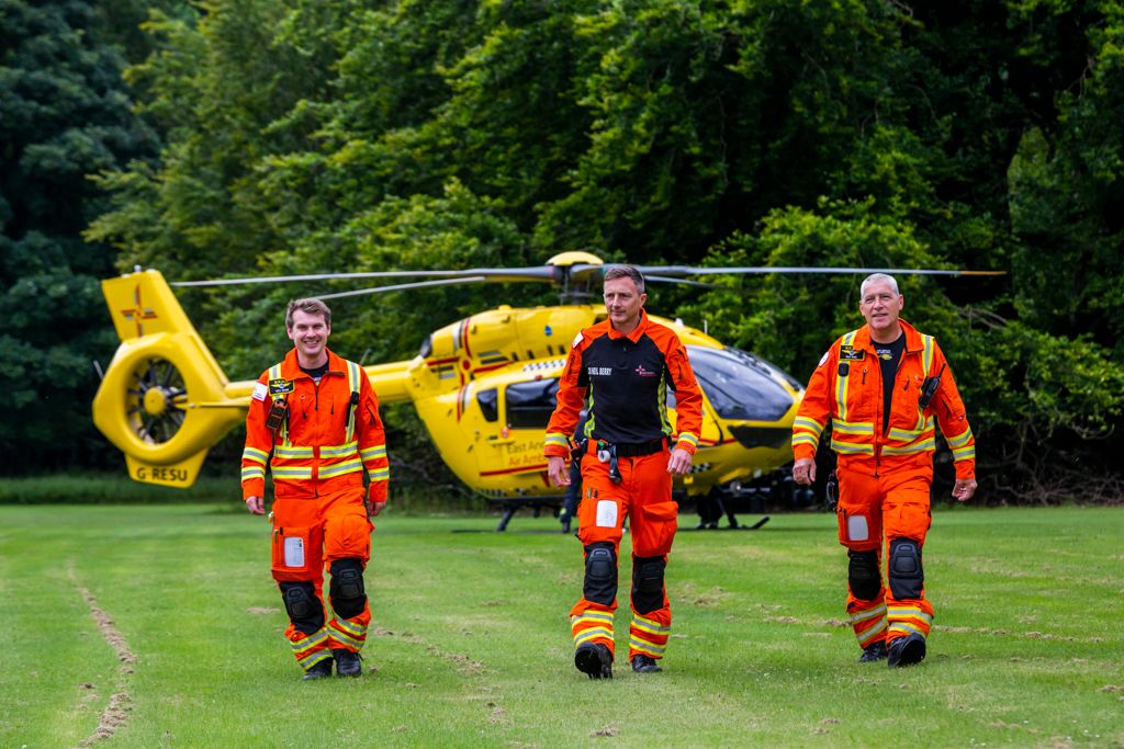 Crew walking away from helicopter on grass