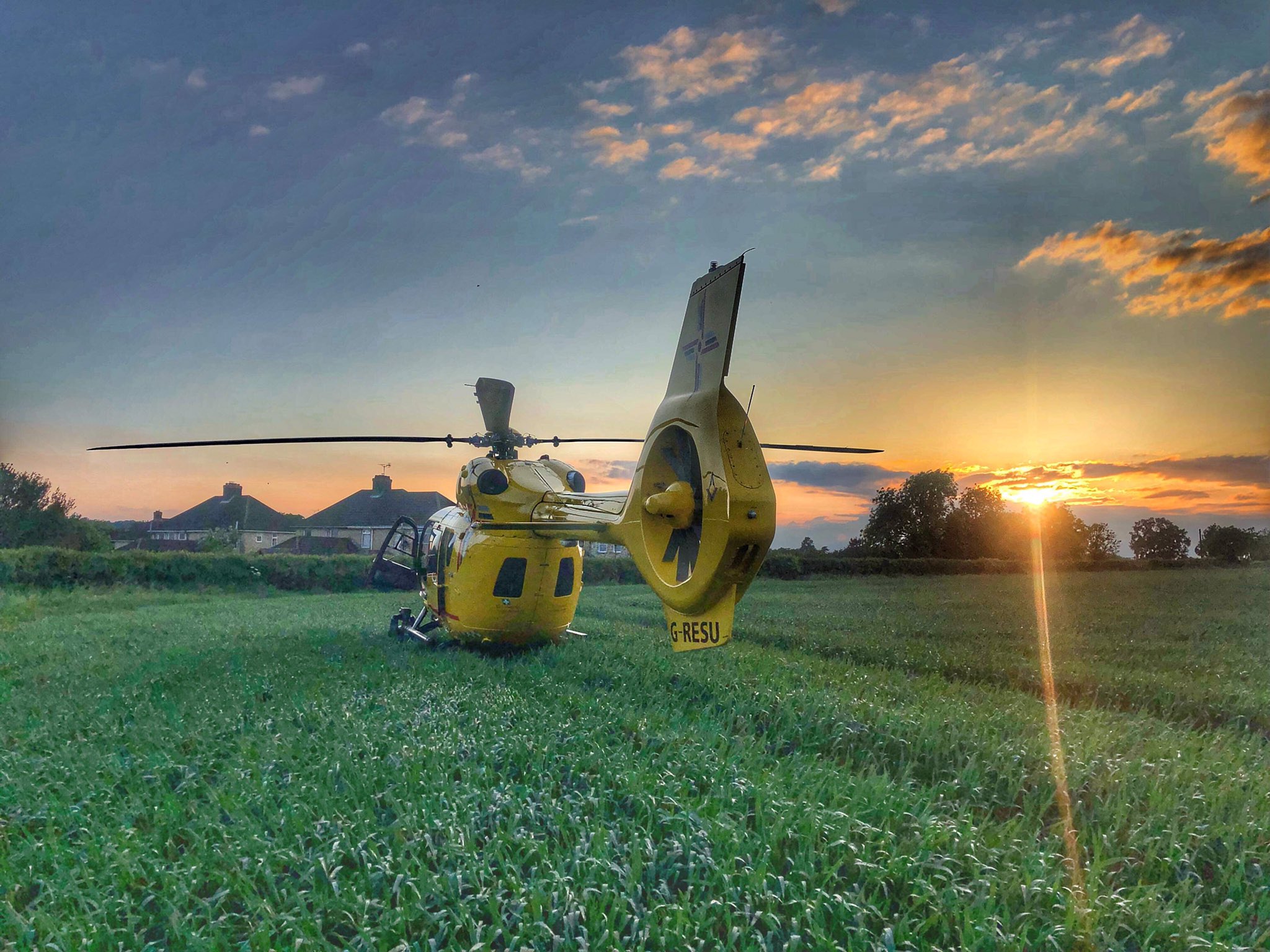 Helicopter in field at sunset