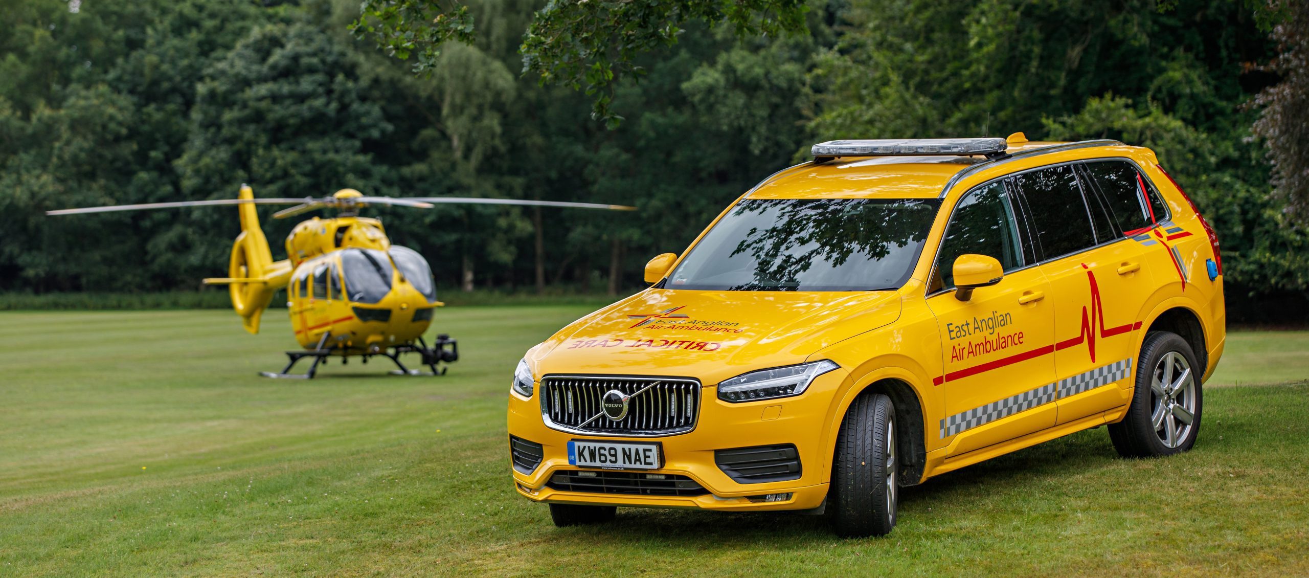 Helicopter and car on grass