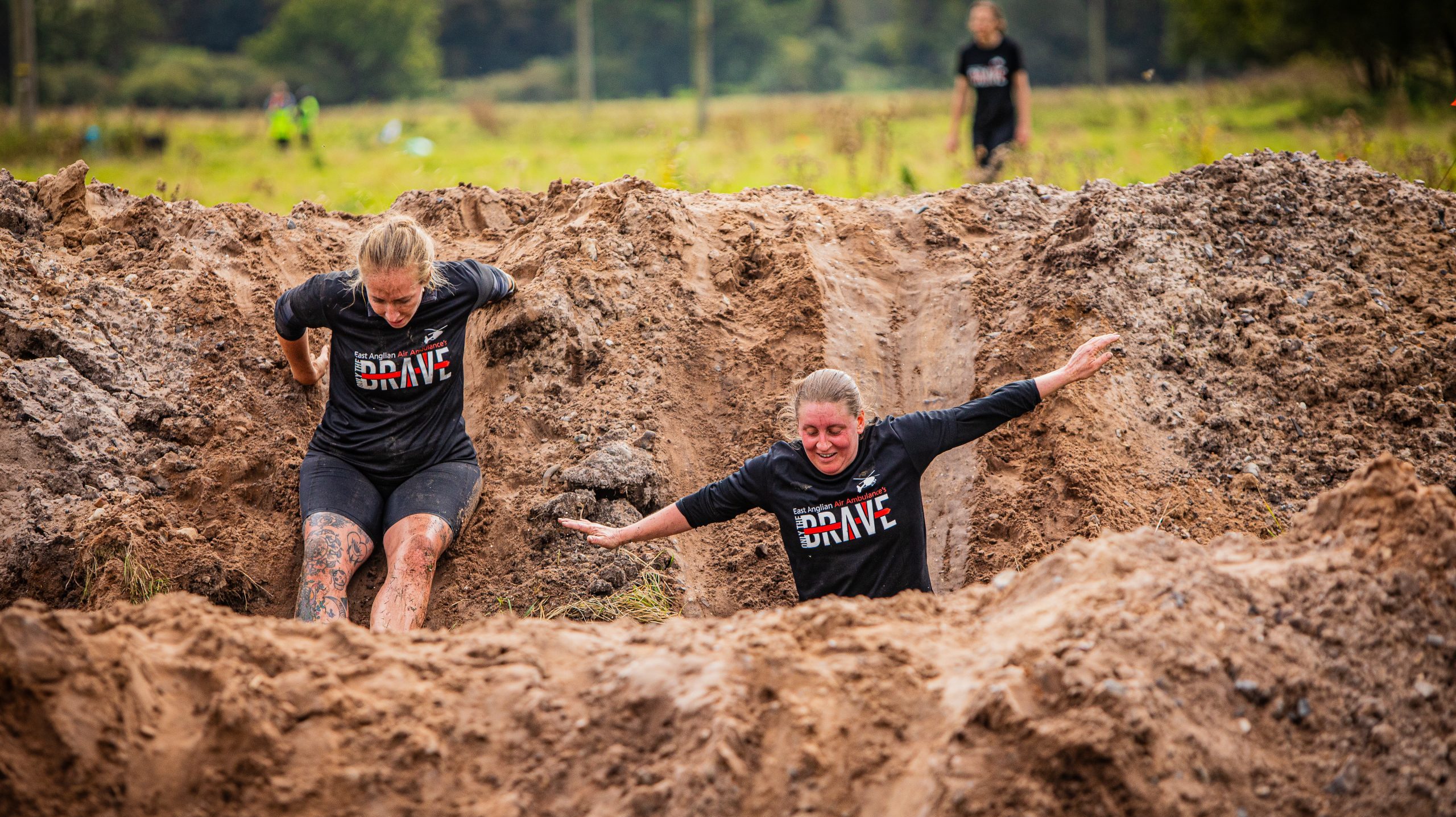 Two women taking on the muddy hills in Only the Brave