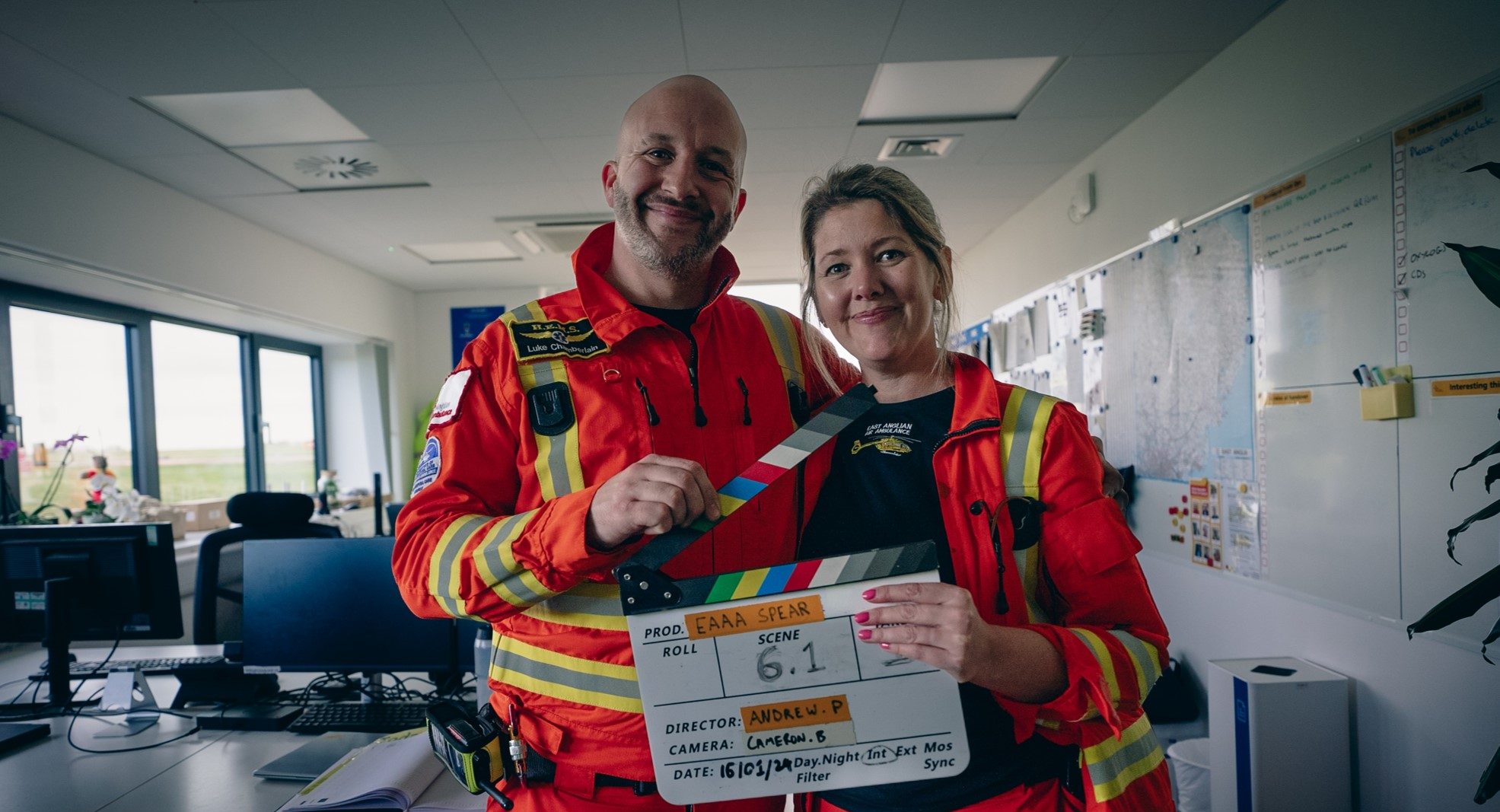 crew holding filming clapper in crew room