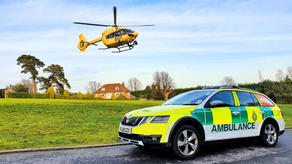 Helicopter landing next to paramedic car