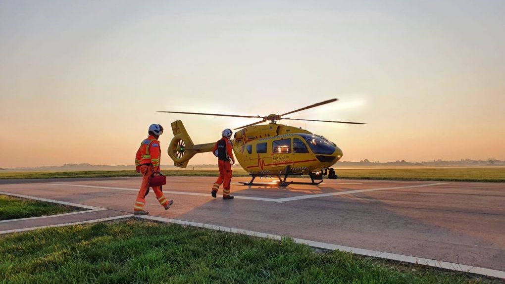 Cambridge crew walking to helicopter