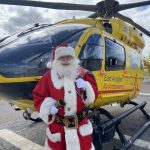 Santa Ron in front of the EAAA helicopter