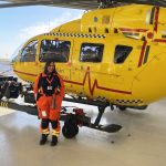 Dr Lesley in front of helicopter